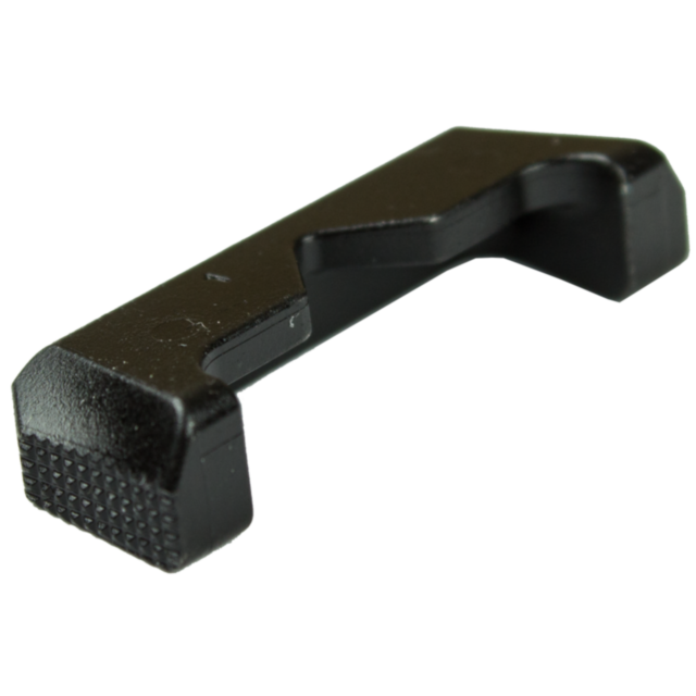 A black, L-shaped plastic object with textured ends, resembling a MAGAZINE CATCH BUTTON P-10. It has a flat base and indents along its sides, suggesting it is possibly a tool or component.