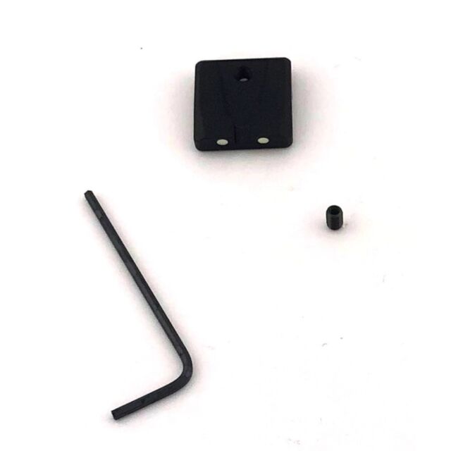 A compact, black square object featuring two white dots is set against a white background. Beside it, a black hex key and a small cylindrical component await assembly. These parts appear to belong to the CZUB Factory Rear Sight for the P-07/P-09 model.