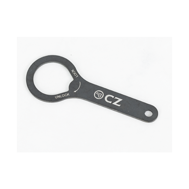 A flat, circular metal tool with a handle, branded with the product name "BARREL BUSHING WRENCH SHADOW 2 ORANGE," displaying the letters "CZ" and the words "LOCK" and "UNLOCK" accompanied by directional arrows. The background is plain white.