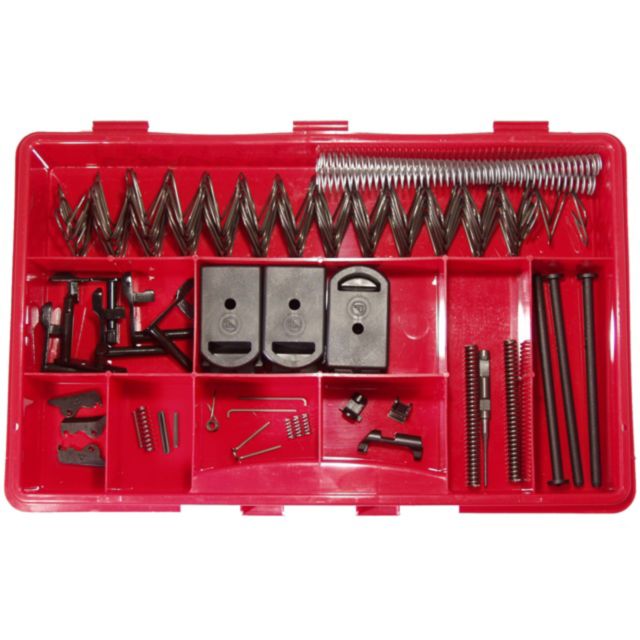 A red plastic organizer neatly arranges springs, levers, and small mechanical components from the SPARE PARTS KIT SP-01 TACTICAL in its various compartments.