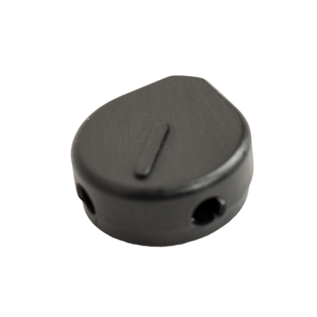 Close-up of the SCORPION EVO AMBI CONTROL DELETE, a small, black, oval-shaped device with a flat top and two circular holes on the side.