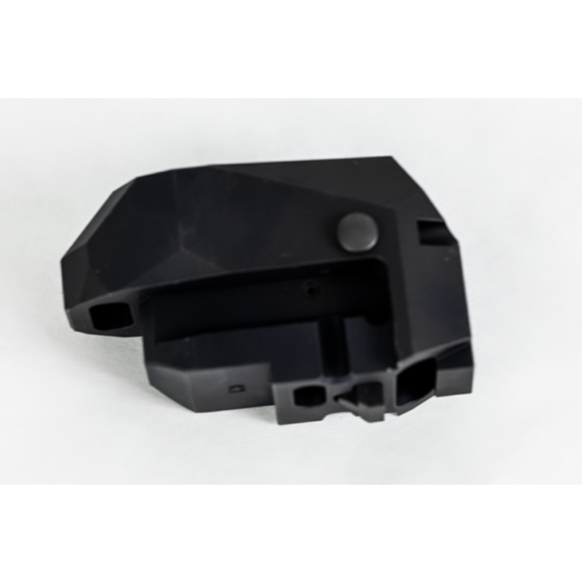 The REAR HEAD ASSEMBLY BREN 2 PISTOL, crafted from black plastic with a geometric design and matte finish, showcases several cutouts and a small protruding button, all set against a white background.