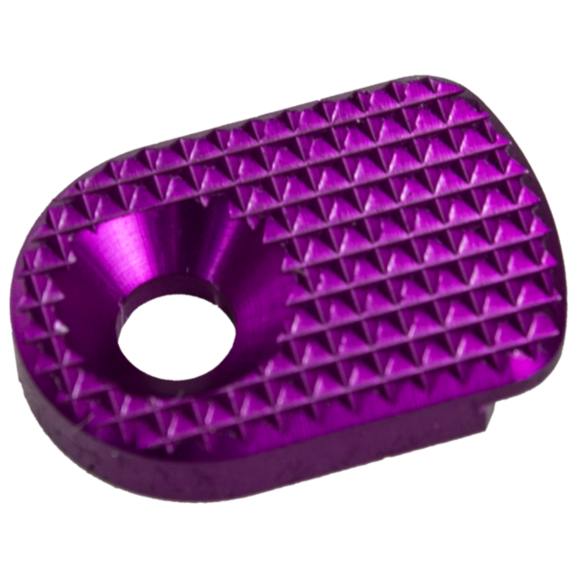 The object is a sleek metal textured item with a purple hue, featuring a triangular pattern and a central circular hole, similar to the MAGAZINE CATCH PADDLE SHADOW 2 PURPLE.