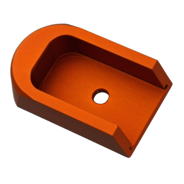 The ORANGE ALUMINUM 40P/SP-01 BASE PAD is an orange metal U-shaped bracket with a central hole, designed to securely hold or support objects. Its sleek, polished finish and sturdy construction make it ideal for various industrial or mechanical application
