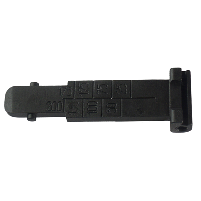The object is a black, rectangular metal piece called the Tangent Rear Sight Leaf 452/455/457. It features engraved numbers: 15, 25, 50, 75, 100, 125, and 200. Resembling a rear sight leaf for models like the 452/455/457 and includes a notch at the end. I