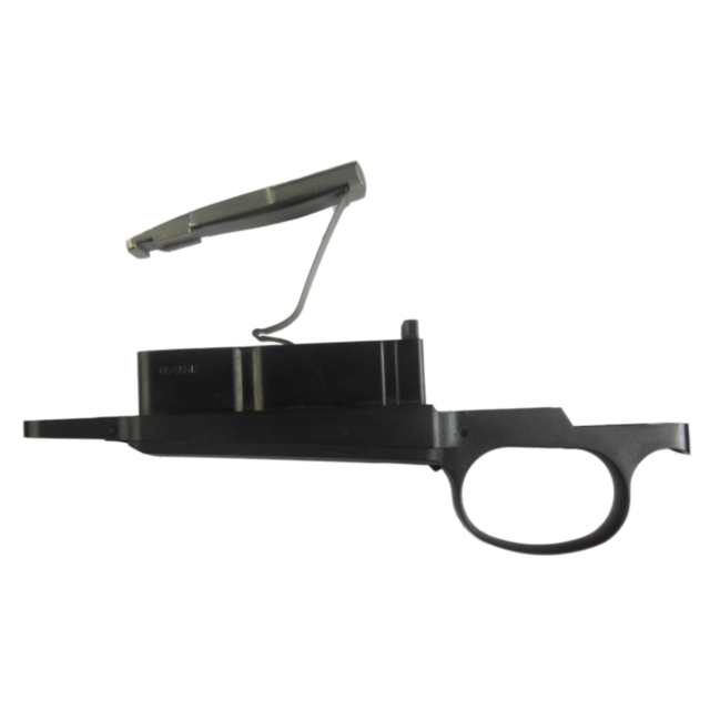 The TRIGGER GUARD COMPLETE 6.5X55 is a black trigger assembly component that includes a magazine release lever, a rectangular magazine well, and an integrated trigger guard. The raised lever makes it ideal for 6.5x55 configurations.