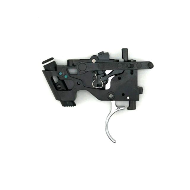 A black Trigger assembly CZ 600, with exposed levers and a metallic trigger, isolated on a white background. It appears to be part of a firearm mechanism.