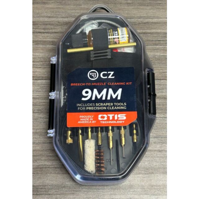 The "CZ Breech-to-Muzzle Pistol Cleaning Kit" in a plastic case contains cleaning solution, a brush, and precision tools for top-notch maintenance, elegantly displayed on a wooden surface.