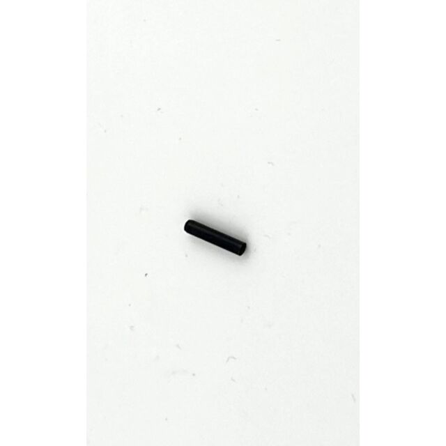A compact black cylindrical item, similar to the DWX EXTRACTOR PIN, rests on a smooth white surface.
