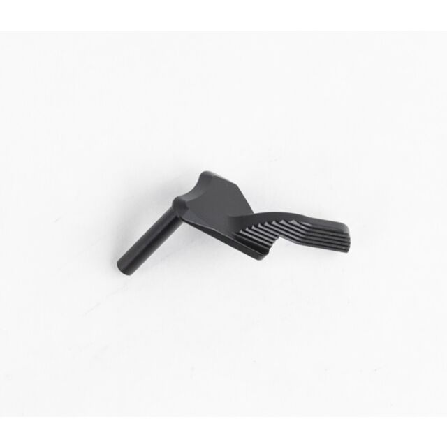 The DWX THUMB SAFETY is a small black metal lever with a textured, angled handle and a short cylindrical post, shown on a plain white background.