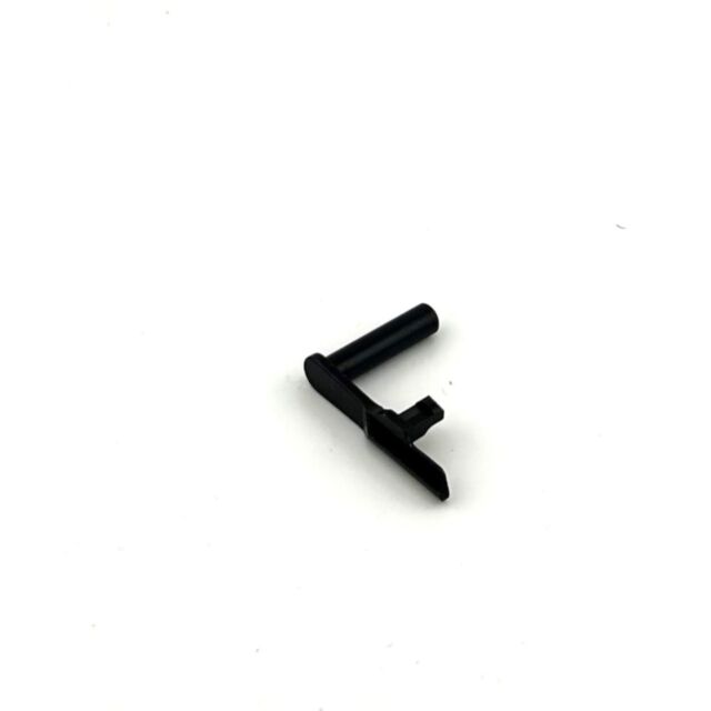 A small, black DWX SLIDE STOP 9MM EXTENDED, DUTY COAT with an L-shaped design and flat base rests on a plain white background.