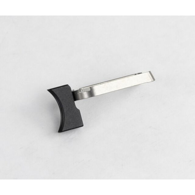 A DWX Full Size Trigger Assembly, Short, Solid, with its distinct angular shape and contrasting black and silver color scheme, features a curved handle and lies on a plain white surface.