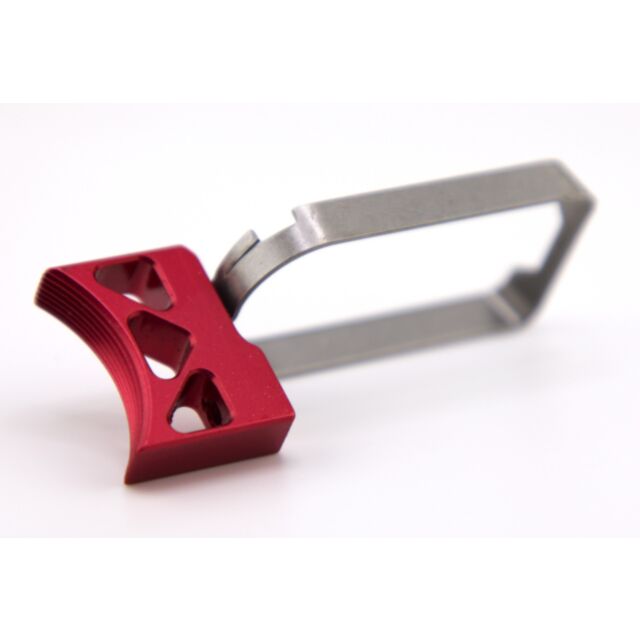 A DWX COMPACT TRIGGER ASM, CURVED K, RED with a small size and modern design features a red, triangular textured grip and a metal frame. The handle is designed with triangular cutouts, all set against a white background.