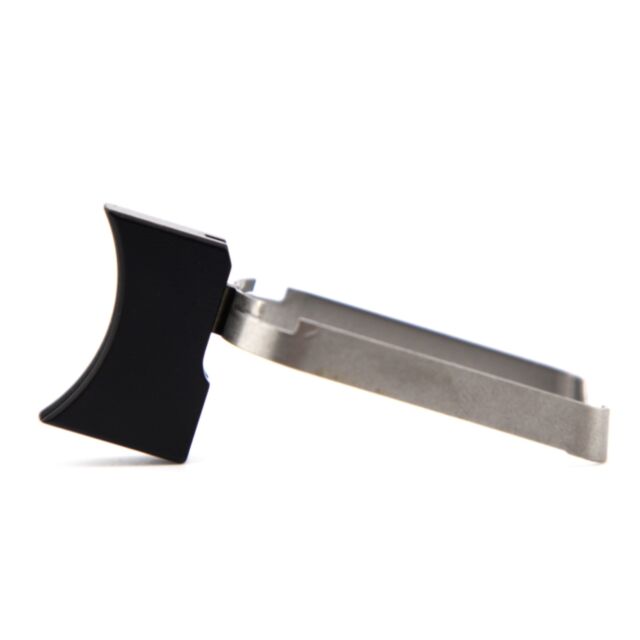 Close-up of a DWX COMPACT TRIGGER ASM, MED. CURVED,BLA, showcasing its metal and black plastic components from a side view. The product features a silver metallic section and a black plastic grip, highlighting its straightforward and practical design agai